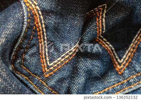 Blue denim fabric macro fabric texture, stitching details, cotton pattern, textile background close-up. Natural background for textile, jeans fashion design, clothing material Blue denim fabric macro fabric texture, stitching details, cotton pattern, textile background close-up. Natural background for textile, jeans fashion design, clothing material 136352132
