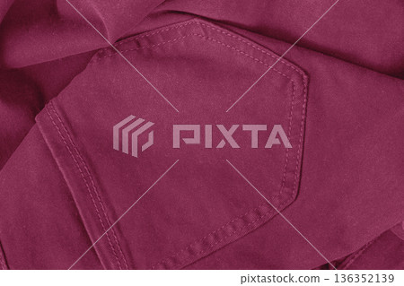 Close-up of red pants pocket showing textile texture and stitch detail. Fashion color trend, fabric texture, textile material, clothing design, color of year, magenta background 136352139