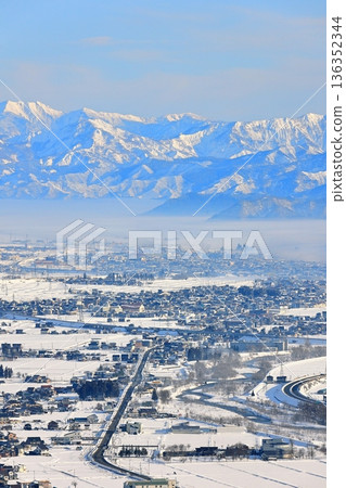 The vast plains of Uonuma and the towering mountains behind them The vast plains of Uonuma and the towering mountains behind them 136352344