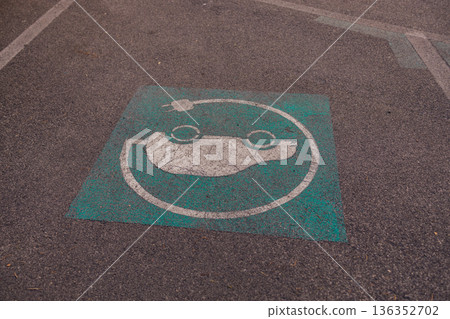 Electric Vehicle Parking Sign Painted on Asphalt 136352702