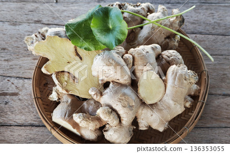 Ginger and gotu kola leaves in a basket. Ginger and gotu kola leaves in a basket. 136353055
