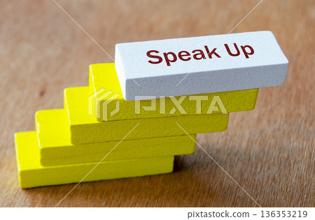 SPEAK UP text on yellow staircase blocks emphasizing step by step empowerment and ethical culture. SPEAK UP text on yellow staircase blocks emphasizing step by step empowerment and ethical culture. 136353219