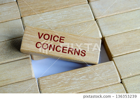 VOICE CONCERNS text on wooden blocks highlighting safe reporting and employee engagement. VOICE CONCERNS text on wooden blocks highlighting safe reporting and employee engagement. 136353239