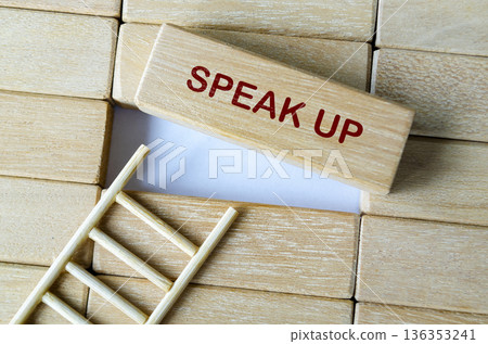 SPEAK UP text on wooden blocks highlighting employee voice and transparent workplace communication. SPEAK UP text on wooden blocks highlighting employee voice and transparent workplace communication. 136353241