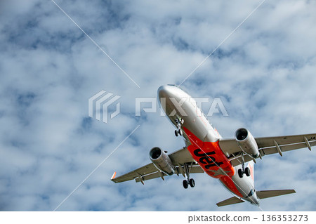 An airplane glides gracefully through the sky 136353273