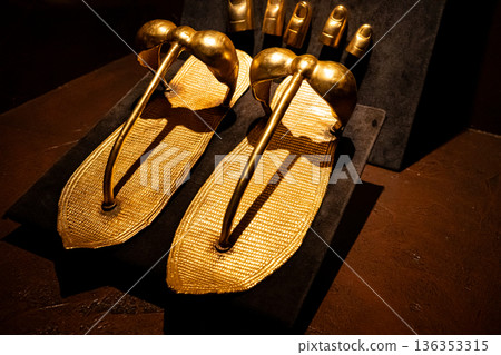 Ancient Egyptian golden sandals displayed in museum interior Ancient Egyptian golden sandals displayed in museum interior 136353315
