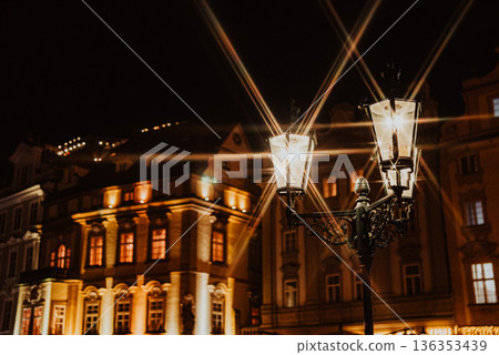 Old street lanterns glowing at night in historic Prague city center Old street lanterns glowing at night in historic Prague city center 136353439