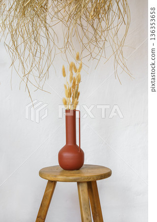 Minimal natural decor, ceramic vases and dry branches on rustic white plaster wall background 136353658