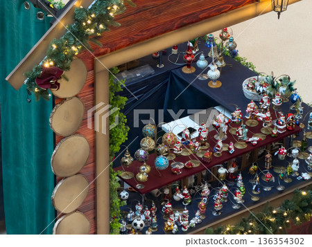 Festive Christmas market stall showcases myriad Santa Claus and themed holiday ornaments, promoting seasonal cheer and traditional festive gift shopping Festive Christmas market stall showcases myriad Santa Claus and themed holiday ornaments, promoting seasonal cheer and traditional festive gift shopping 136354302