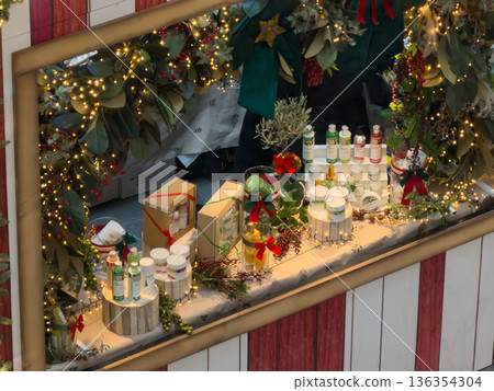 Festive Christmas market stall presents natural cosmetic and organic skincare products adorned with glowing lights and winter foliage, inspiring holiday gift ideas Festive Christmas market stall presents natural cosmetic and organic skincare products adorned with glowing lights and winter foliage, inspiring holiday gift ideas 136354304