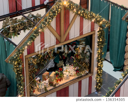 Festive Christmas market stall adorned with sparkling lights and green garlands, showcasing unique artisan gifts for seasonal celebrations 136354305