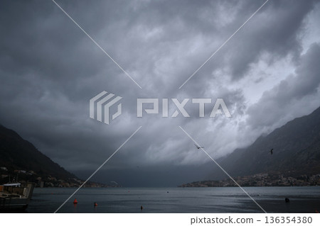 Stormy Coastal Bay With Mountains and Overcast Sky Stormy Coastal Bay With Mountains and Overcast Sky 136354380