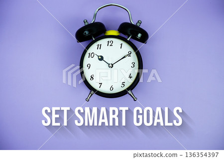 Set Smart Goals text and alarm clock on purple background 136354397