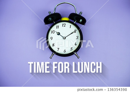 Time For Lunch text and alarm clock on purple background 136354398