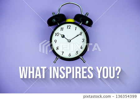 What Inspires You? text and alarm clock on purple background 136354399