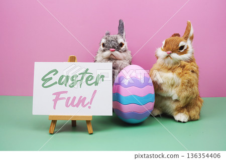 Easter Fun! text with rabbit and egg on pink and green background 136354406
