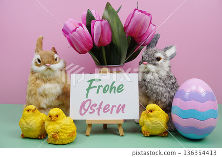 Frohe Ostern text with easter elements decoration on pink and green background 136354413