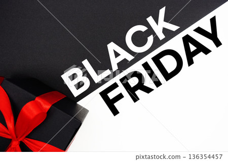 Black Friday text with gift box present on black and white background Black Friday text with gift box present on black and white background 136354457