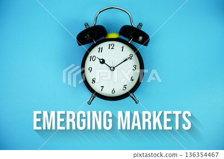 Emerging Markets text and alarm clock on blue background Emerging Markets text and alarm clock on blue background 136354467