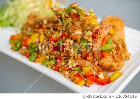 Stir fried shrimp with salt and chili, served on plate with vegetable Stir fried shrimp with salt and chili, served on plate with vegetable 136354539