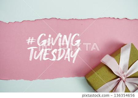 Giving Tuesday text with gift box present on pink background 136354656