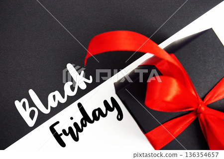 Black Friday text with gift box present on black and white background Black Friday text with gift box present on black and white background 136354657