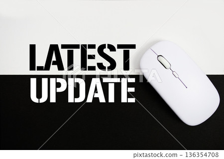Latest Update text and wireless mouse on white and black background 136354708
