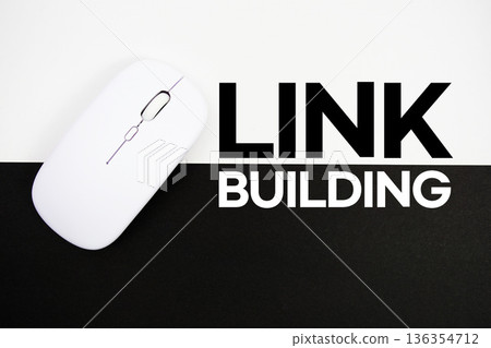 Link Building text and wireless mouse on white and black background 136354712