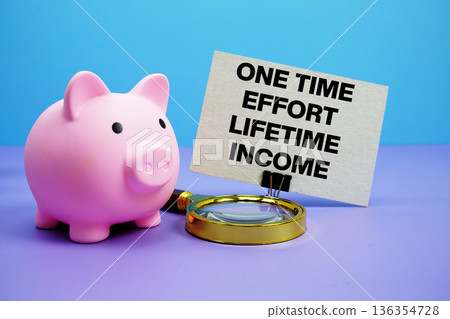 One Time Effort Lifetime Income text with piggy bank and magnifying glass on blue and purple background One Time Effort Lifetime Income text with piggy bank and magnifying glass on blue and purple background 136354728