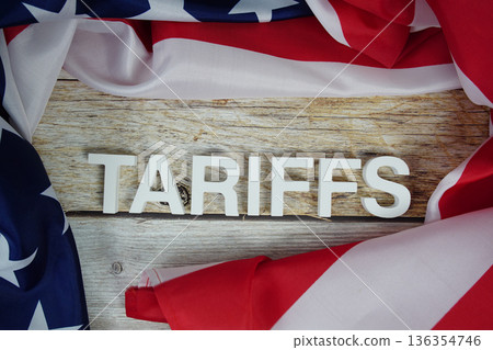 Tariffs alaphbet letters with usa flag on wooden background Tariffs alaphbet letters with usa flag on wooden background 136354746