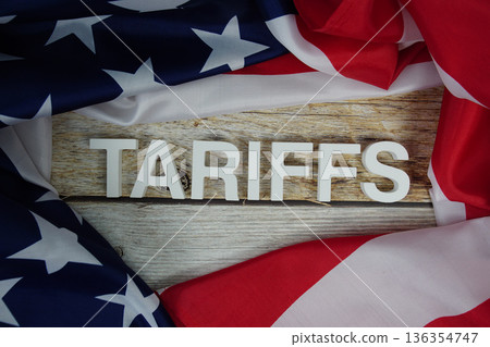 Tariffs alaphbet letters with usa flag on wooden background Tariffs alaphbet letters with usa flag on wooden background 136354747