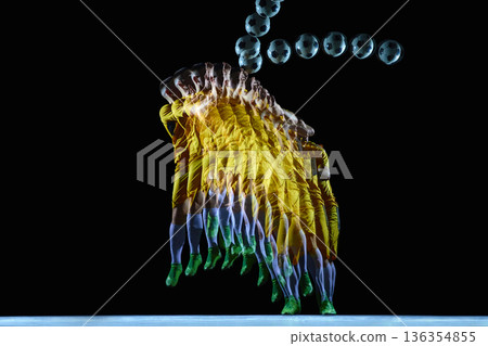 Dynamic football player performing jumping header motion sequence on black background. 136354855