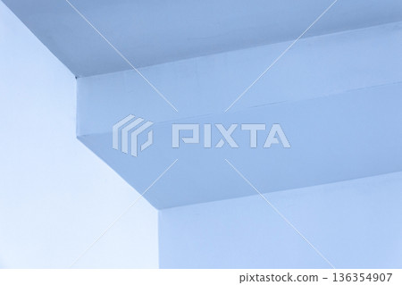 A calm blue interior corner with sharp angles and soft light 136354907