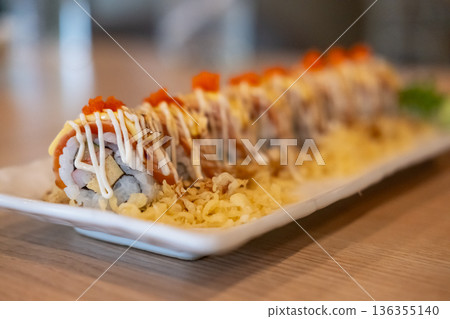 Burned Salmon Sushi roll with cheese served on plate Burned Salmon Sushi roll with cheese served on plate 136355140