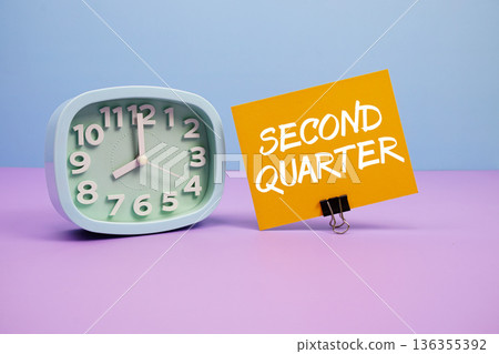 Second Quarter text and alarm clock on blue and purple background 136355392