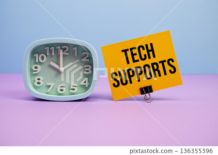 Tech Supports text and alarm clock on blue and purple background 136355396
