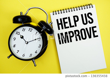 Help Us Improve text with alarm clock flat lay on yellow background Help Us Improve text with alarm clock flat lay on yellow background 136355438