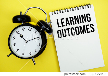 Learning Outcomes text with alarm clock flat lay on yellow background Learning Outcomes text with alarm clock flat lay on yellow background 136355440