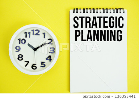 Strategic Planning text with alarm clock flat lay on yellow background 136355441