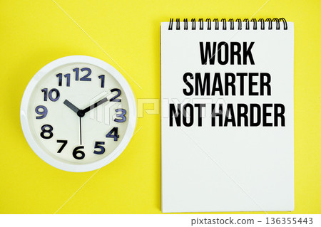 Work Smarter Not Harder text with alarm clock flat lay on yellow background Work Smarter Not Harder text with alarm clock flat lay on yellow background 136355443