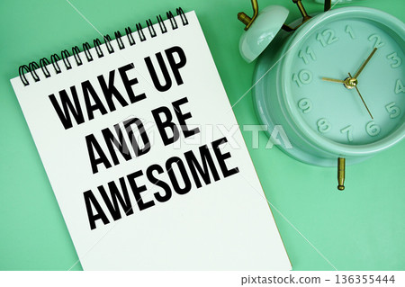 Wake Up And Be Awesome text with alarm clock flat lay on green background Wake Up And Be Awesome text with alarm clock flat lay on green background 136355444