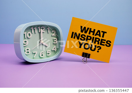 What Inspires You? text and alarm clock on blue and purple background 136355447