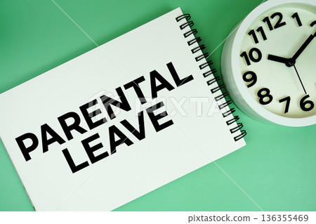 Parental Leave text with alarm clock flat lay on green background 136355469