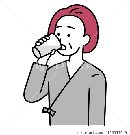 Middle-aged woman in examination clothes drinking barium 136355649
