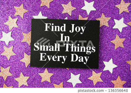 "Find Joy In small Things Every Day" quotes on paper card with purple glitter background with pink and white stars "Find Joy In small Things Every Day" quotes on paper card with purple glitter background with pink and white stars 136356648