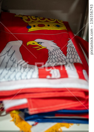 Folded polish Serbian flag with white eagle coat of arms Folded polish Serbian flag with white eagle coat of arms 136356743