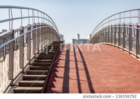 Empty pedestrian overpass with stairs and red walkway 136356792