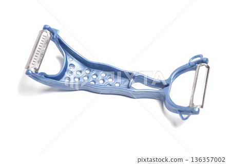 Blue vegetable peeler isolated on white Blue vegetable peeler isolated on white 136357002