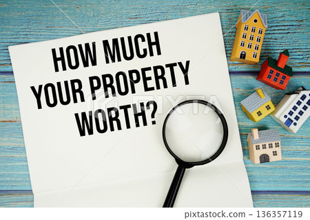 Notepad with "How Much Your Property Worth?" with magnifying glass and house model on wooden background Notepad with "How Much Your Property Worth?" with magnifying glass and house model on wooden background 136357119