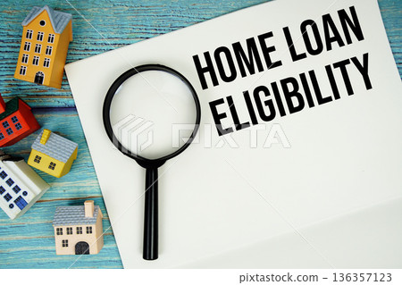 Notepad with "Home Loan Eligibility" with magnifying glass and house model on wooden background Notepad with "Home Loan Eligibility" with magnifying glass and house model on wooden background 136357123